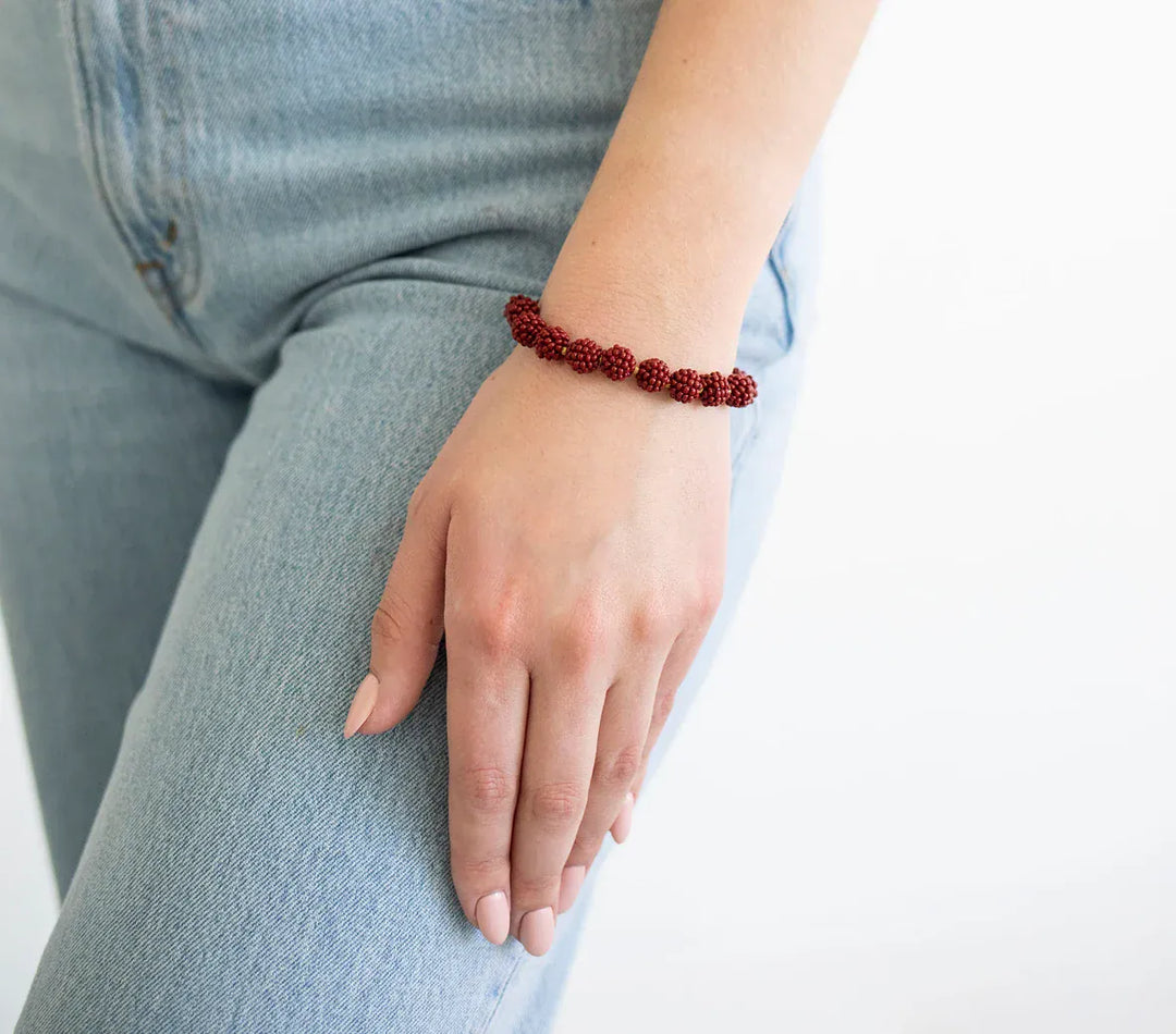 Aid Through Trade globe bracelet, stylish accessory featuring a detailed globe charm on a durable bracelet band.