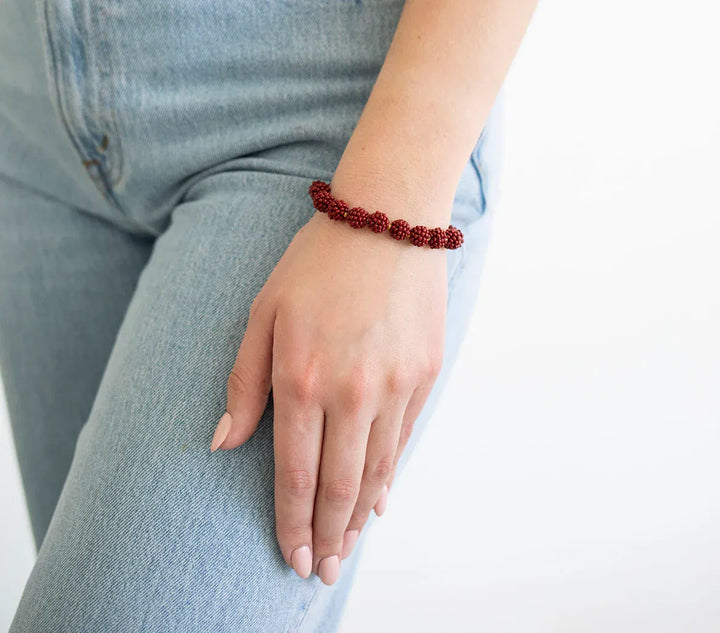 Aid Through Trade globe bracelet, stylish accessory featuring a detailed globe charm on a durable bracelet band.