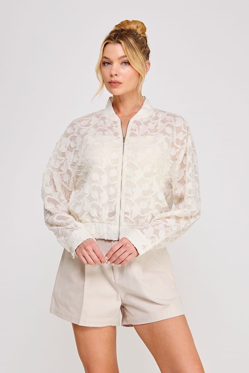 Allie Rose Lea semi-sheer off-white blouse jacket displayed on a hanger, showcasing lightweight, stylish jacket with semi-transparent fabric.