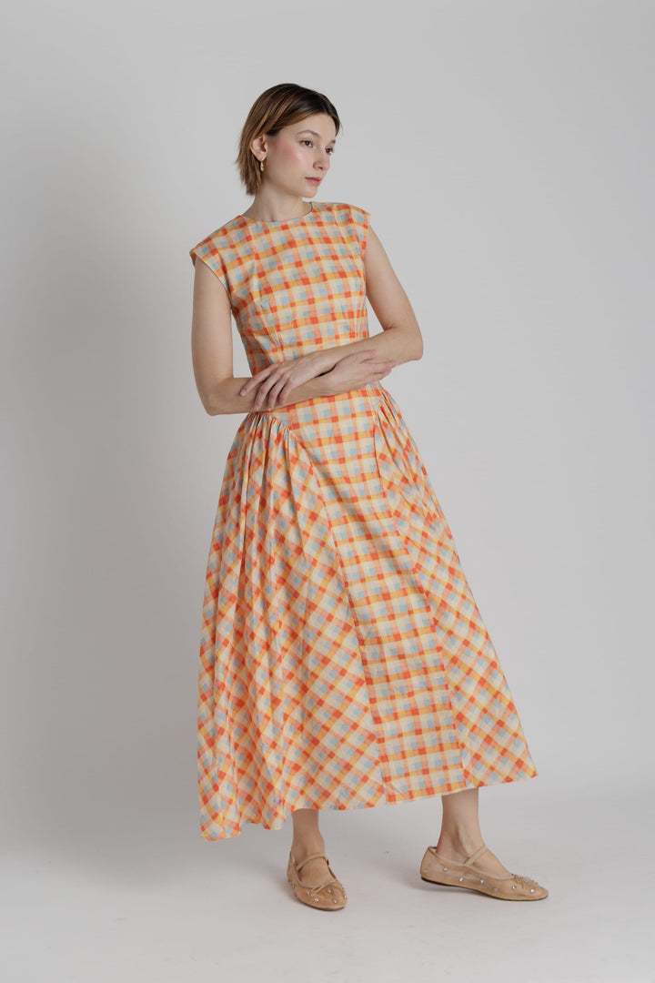 Aureum Mila plaid midi dress featuring a classic checkered pattern, V-neckline, and relaxed fit, perfect for casual or semi-formal occasions.