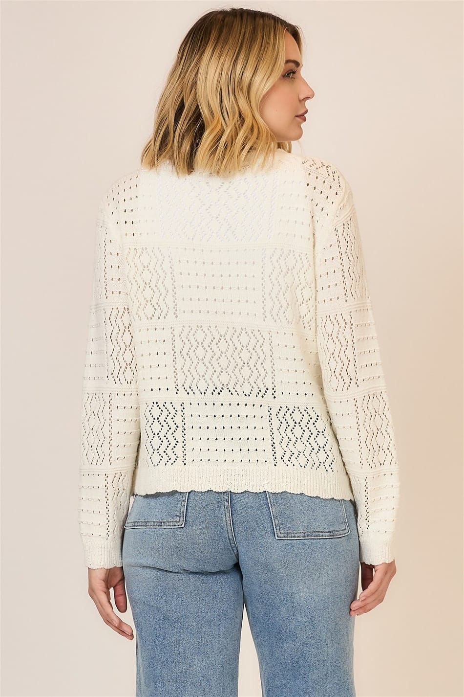 Cozy Co. Alice open-knit cardigan displayed on a hanger, featuring lightweight knit fabric and relaxed fit in neutral tones.