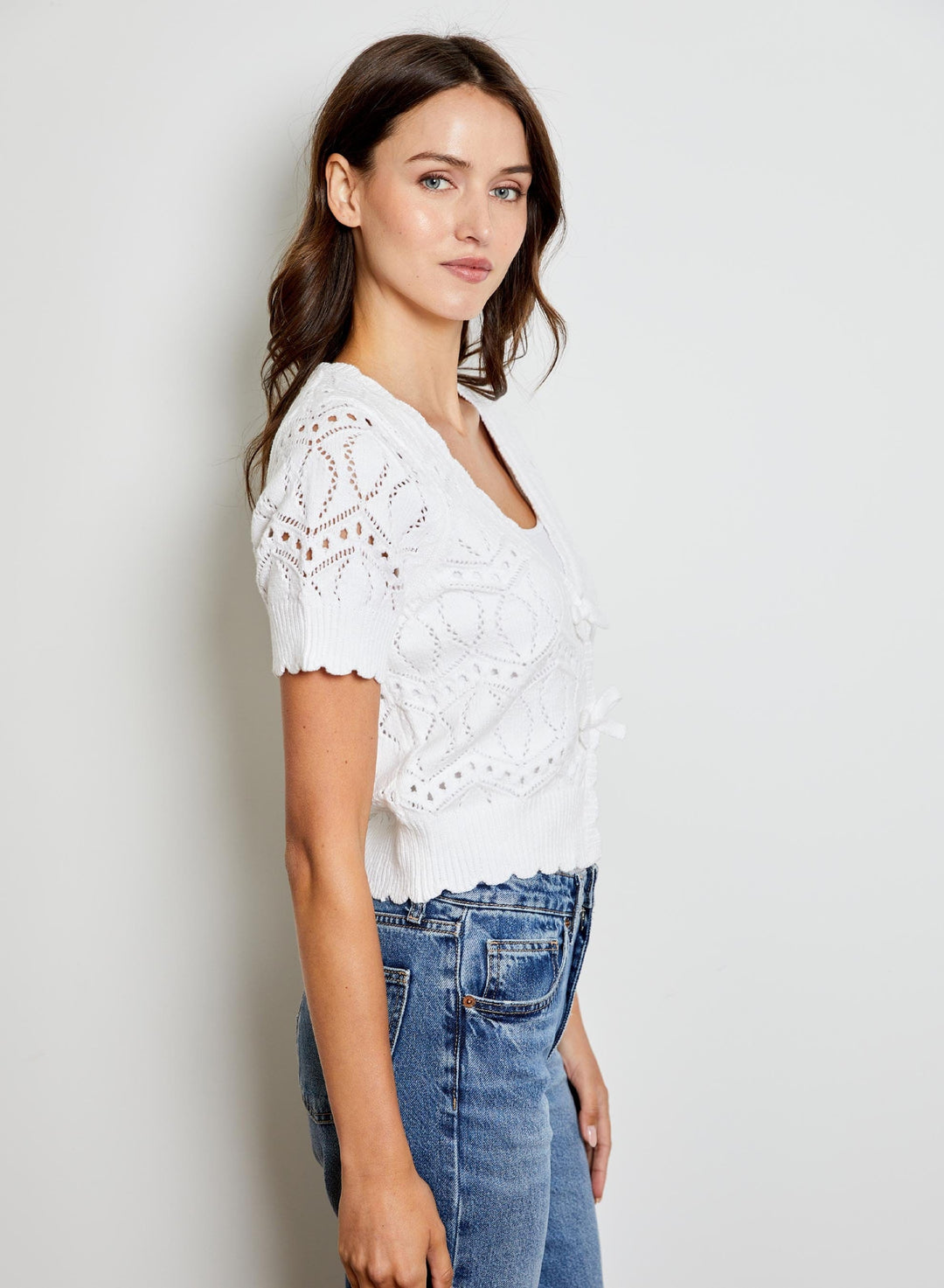 Eliana V-Neck Bow Sweater by Design History New York, featuring a V-neck design and bow detail in soft knit fabric.
