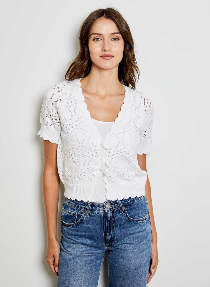 White Eliana V-Neck Bow Sweater by Design History New York, featuring a V-neck and bow detail, shown on a model.