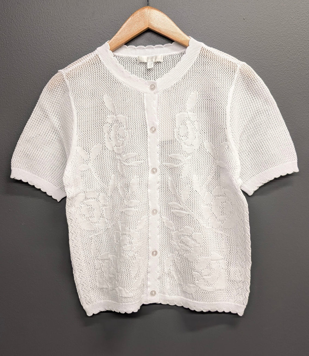 White Lila open-knit top by Design History New York, showing a lightweight, breathable fabric with a relaxed fit and open knit pattern.