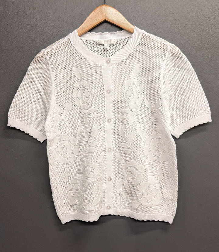 White Lila open-knit top by Design History New York, showing a lightweight, breathable fabric with a relaxed fit and open knit pattern.