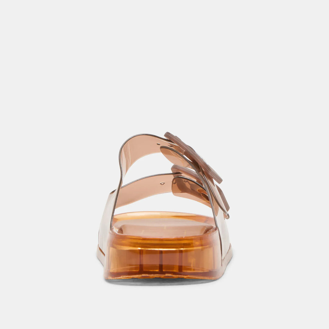 Dolce Vita Julio Sandals featuring strappy design and flat sole, shown in natural light with tan leather straps.