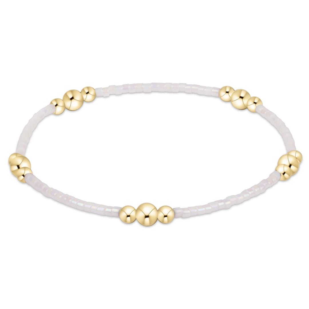 Enewton Hope Purpose gold bracelet with silky white band, elegant jewelry accessory featuring a sleek design.