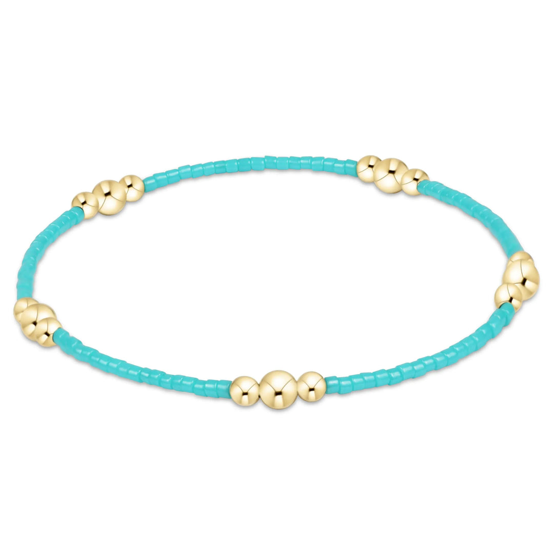 Enewton Hope Purpose gold bracelet featuring turquoise stones, showcasing a stylish and elegant jewelry accessory.