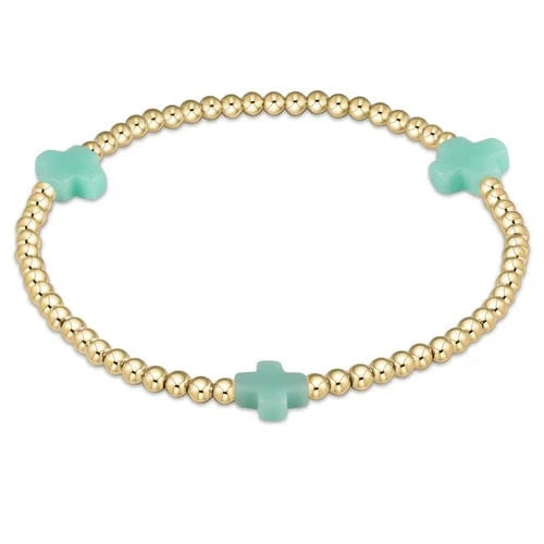 Enewton Signature Cross 3mm gold bracelet with mint beads, featuring a cross pattern and stylish bead design.