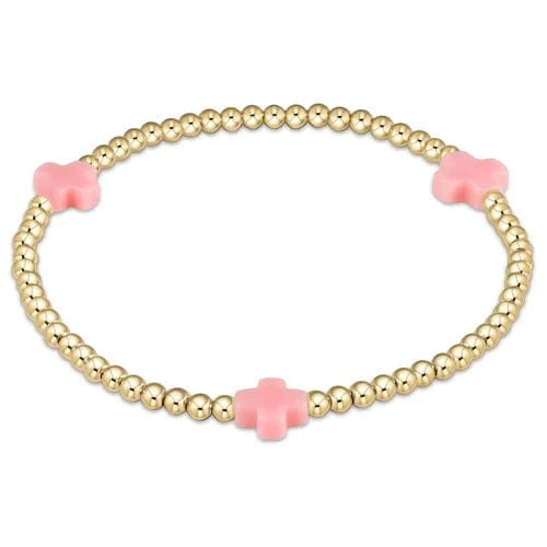 Pink enewton Signature Cross gold pattern 3mm bead bracelet featuring intricate cross design and stylish gold accents.