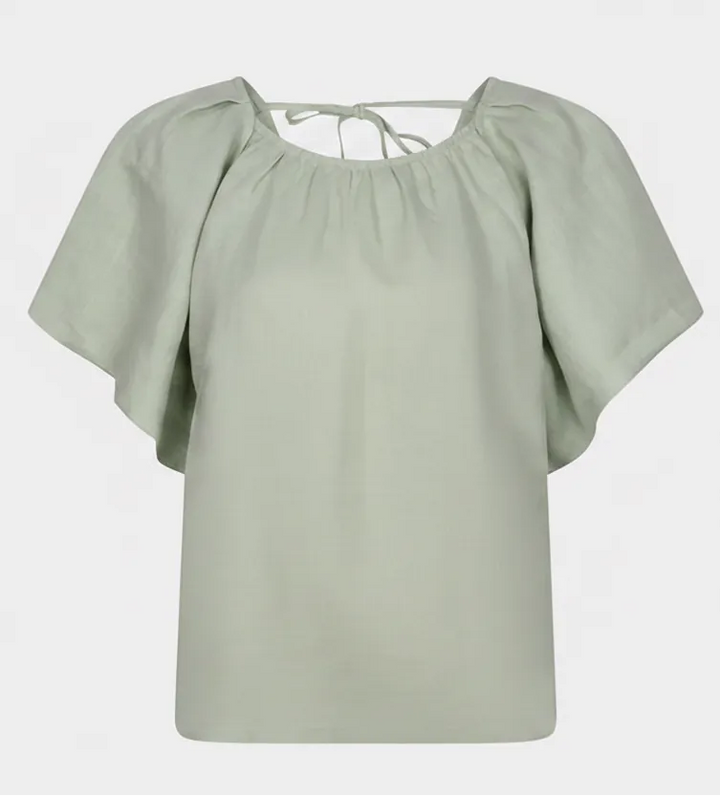 Soft green Esqualo Anna Back Bow Top displayed on a hanger, showcasing the stylish back bow detail and lightweight fabric.