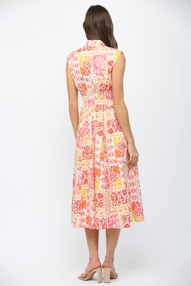 Fate Nora Patchwork Midi Dress displayed on a hanger, showcasing its vibrant patchwork design and midi length.