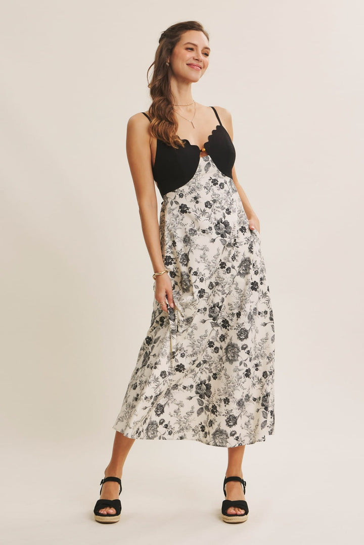 In February midi dress with eye-catching scallop cutout contrast design, stylish and elegant for special occasions.