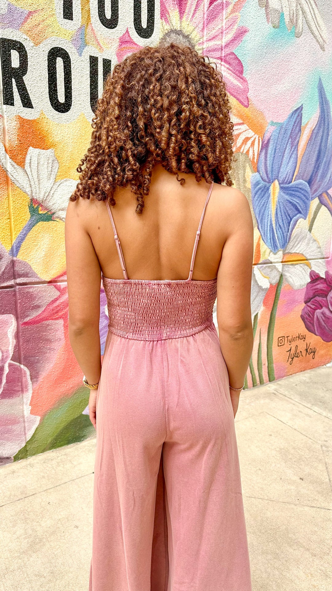 J.NNA Hailey wide-leg jumpsuit featuring a relaxed fit, sleeveless design, and stylish neckline, displayed on a hanger.