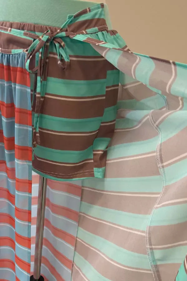 J.NNA Sunset Stripe Maxi Skirt with wrap design featuring vibrant sunset-inspired stripes and flowy fabric.