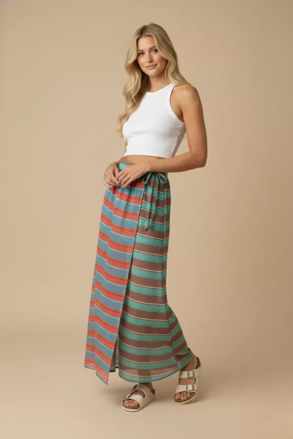 J.NNA Sunset Stripe Maxi Skirt with wrap design featuring vibrant sunset-colored stripes and flowing fabric.