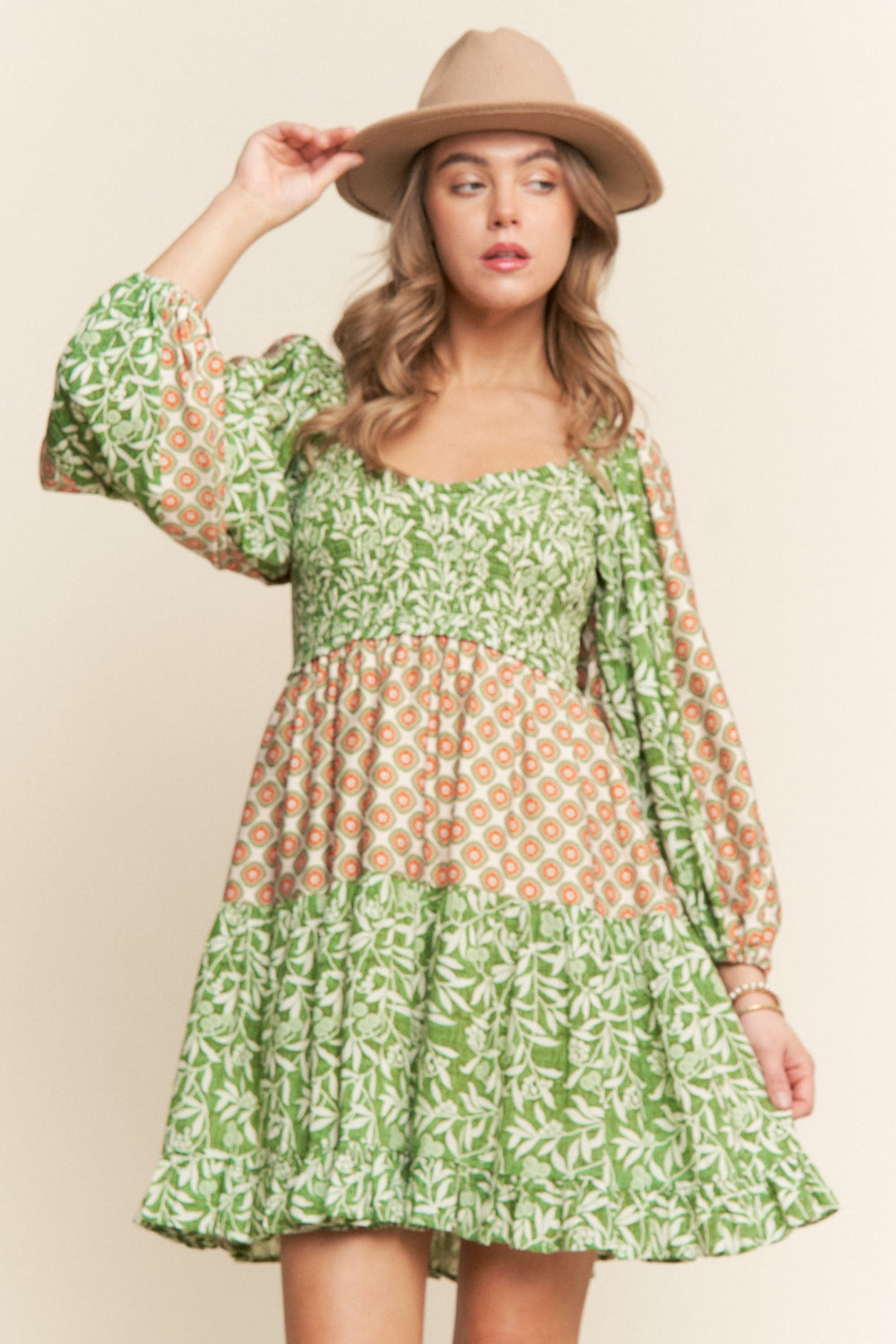 J.NNA Milie Pattern Mini Dress showing a stylish, short dress with a colorful, floral pattern and fitted silhouette.