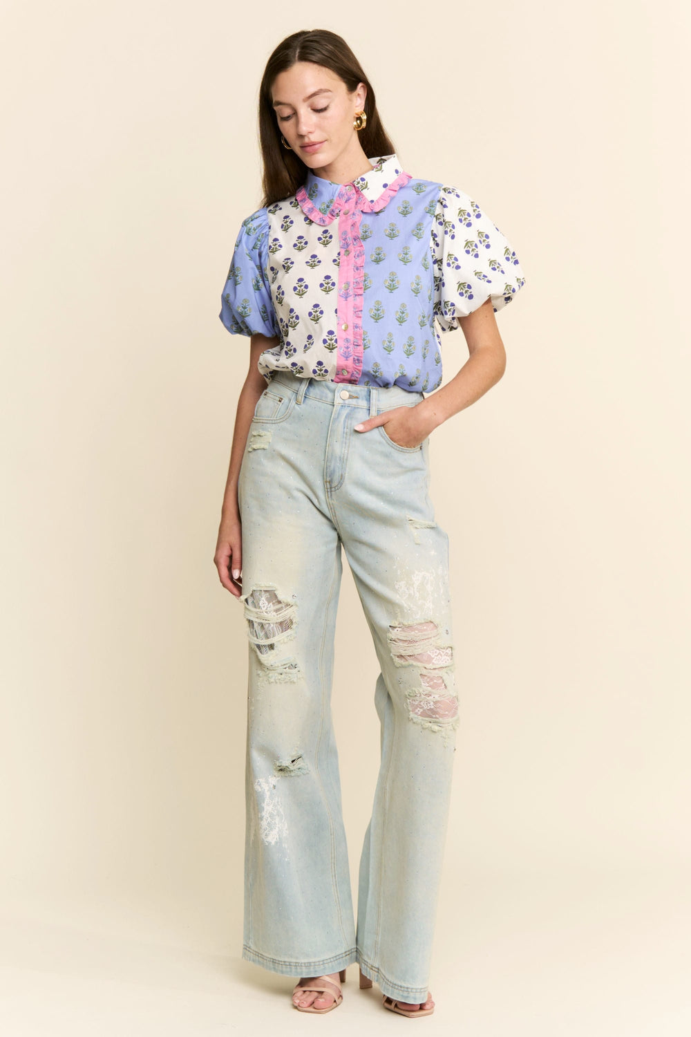 J.NNA Cora floral colorblock top featuring a vibrant floral pattern and colorblocking design, displayed on a white background.