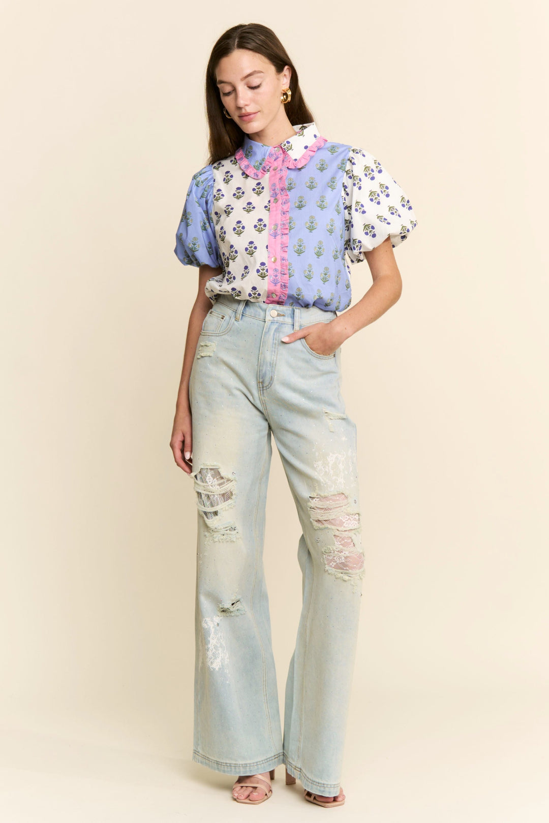 J.NNA Cora floral colorblock top featuring vibrant floral patterns and color blocking, displayed on a plain background
