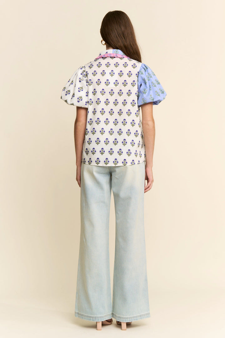 J.NNA Cora floral colorblock top featuring vibrant floral patterns and contrasting color blocks, casual and stylish for everyday wear.