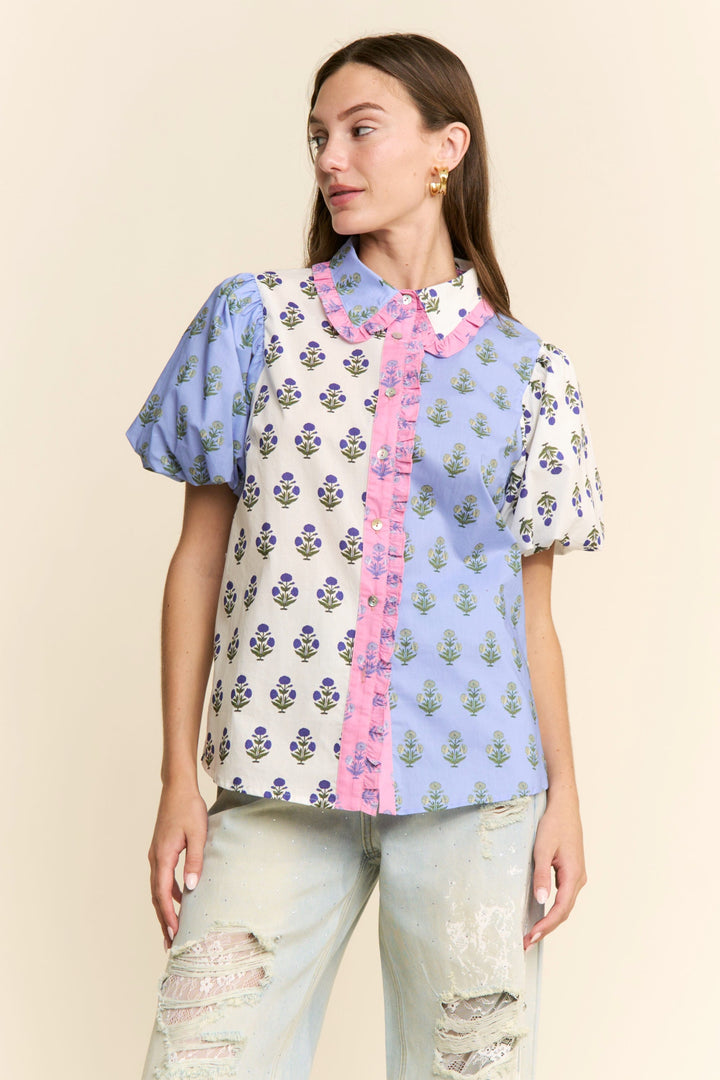 J.NNA Cora floral colorblock top featuring vibrant floral patterns and a stylish design, showcased on a white background.