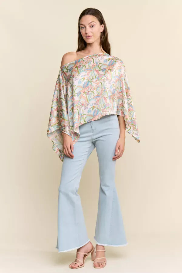J.NNA Sunset Palm Drape Top shown on a model, featuring flowy fabric and tropical print, perfect for casual summer wear.