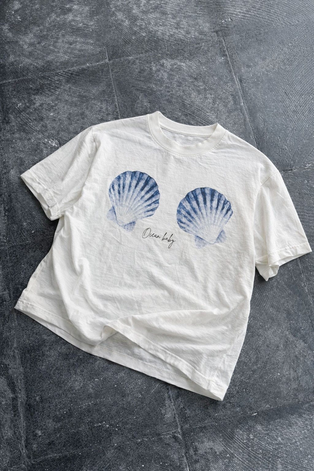 Off-white Ocean Baby Shell graphic tee by Jade by Jane, featuring a seashell design on a casual cotton t-shirt.