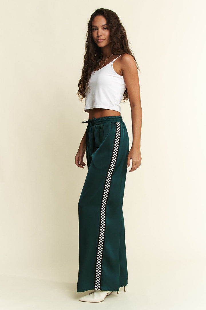 Green satin Isabel sweatpants by Jade by Jane, stylish and comfortable pants with a relaxed fit and satin finish.