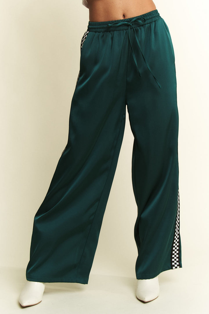 Jade by Jane Isabel satin sweatpants with a relaxed fit and silky sheen, featuring an elastic waistband and cuffed ankles.
