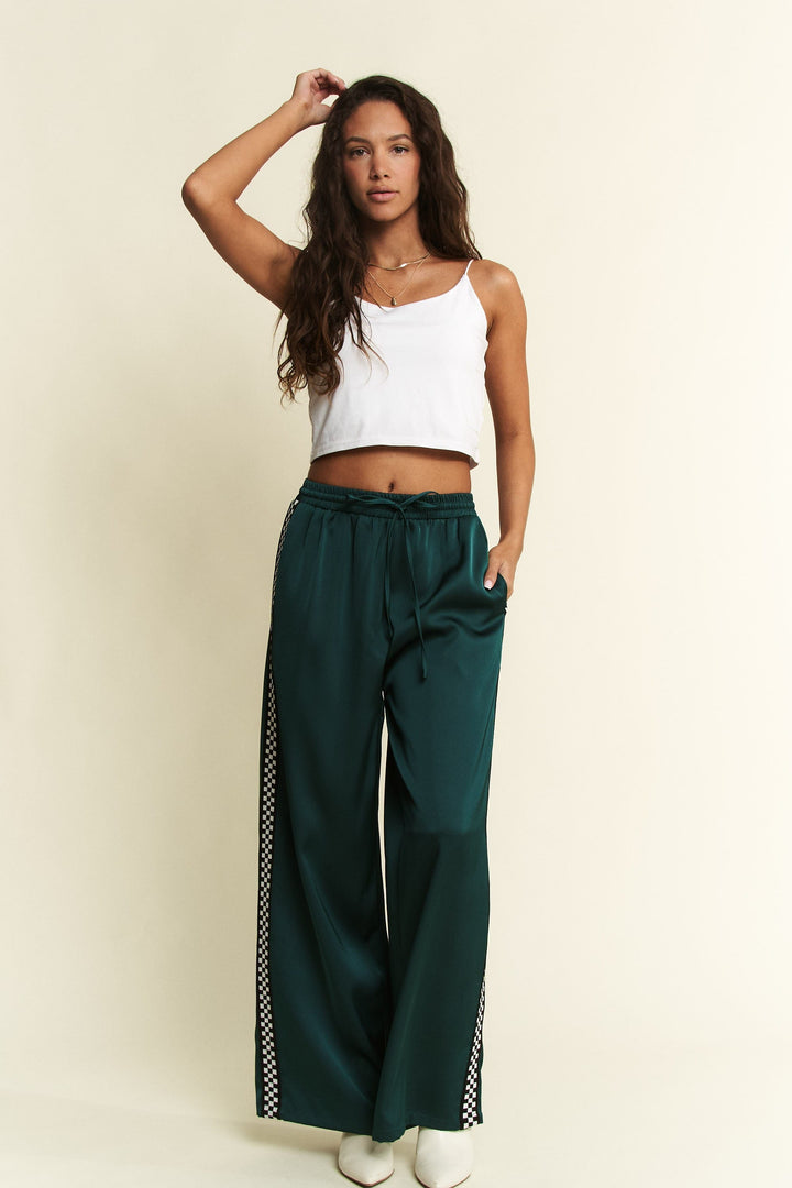 Jade by Jane Isabel satin sweatpants with a relaxed fit and elastic waistband, shown in a soft satin fabric.