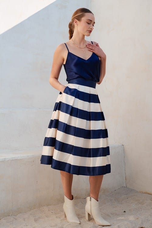 Navy Jade by Jane Piper pleated midi skirt with flowing fabric and elegant design, styled for a sophisticated look.