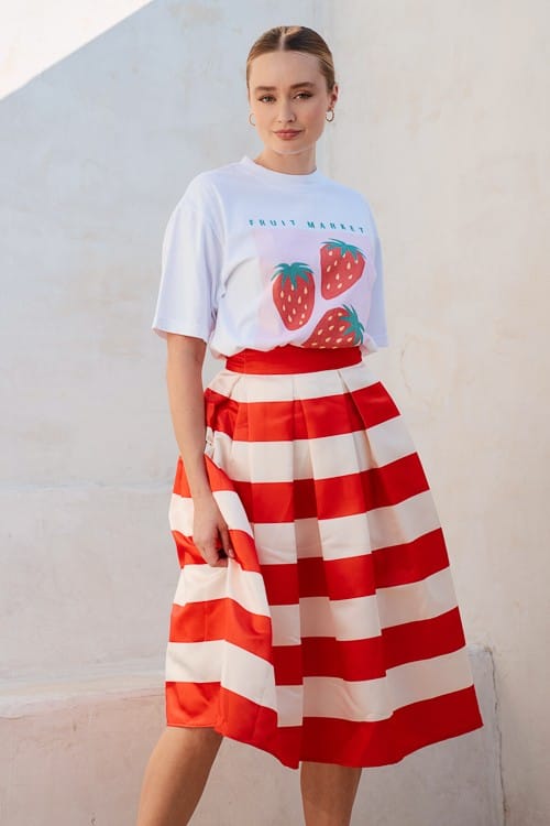 Orange Piper pleated midi skirt by Jade by Jane featuring flowing fabric and elegant pleats.