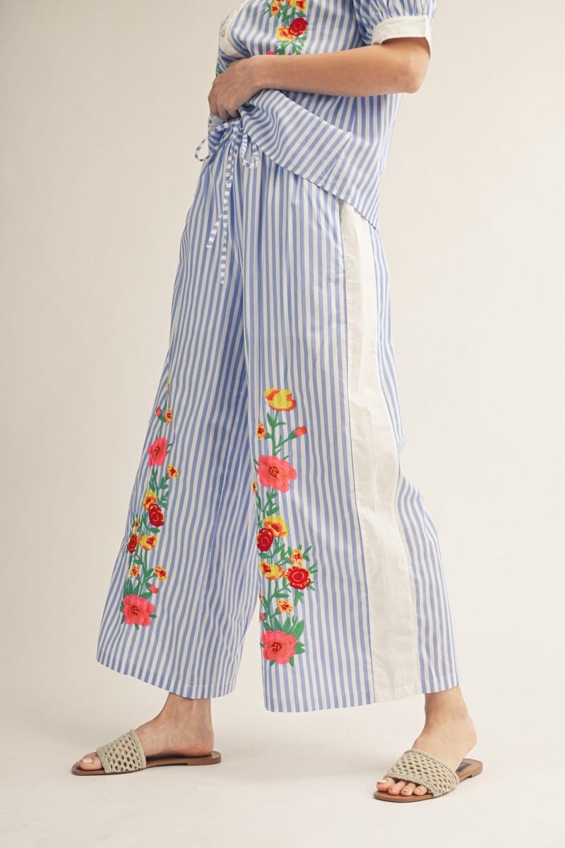 Jodifl Pamela striped pants with a relaxed fit and vertical blue and white stripes, shown on a model.