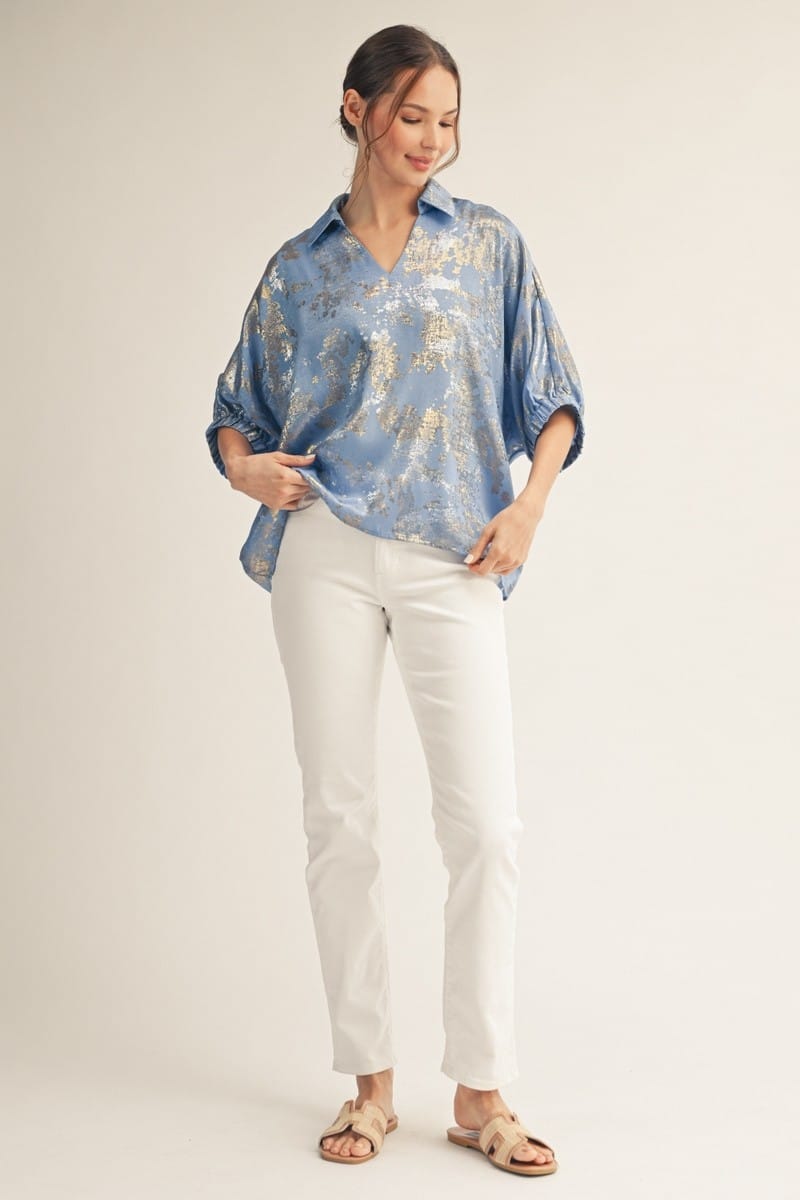 Jodifl Kendra metallic top featuring shiny fabric and a stylish fit, shown on a model with long sleeves and a modern design.