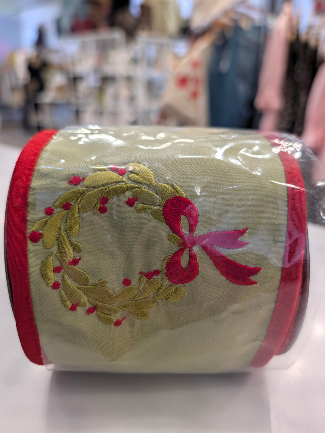 Decor embroidered joy wreath featuring John Mark Ribbon from John Mark Enterprises, with colorful fabric and decorative embellishments.