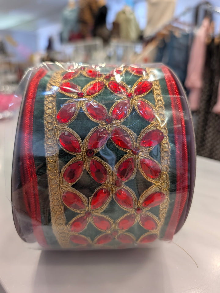 Green velvet decorative ribbon with red floral center by John Mark Enterprises, ideal for festive decor and craft projects.