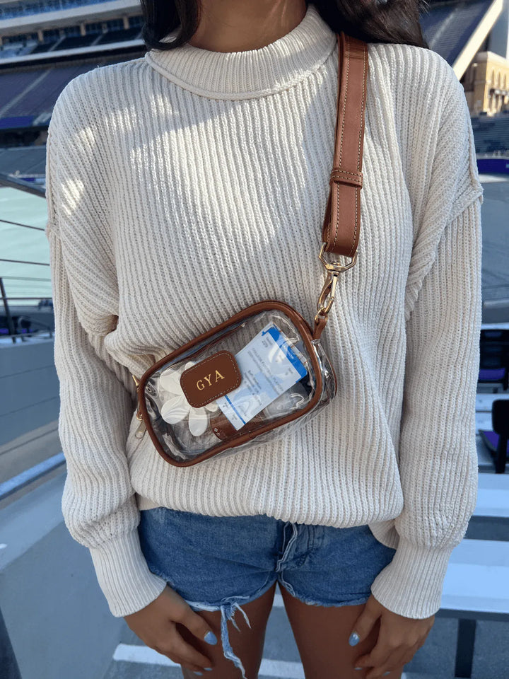 Jon Hart Design Clear Crosslet bag with transparent material and crossbody strap, showcasing a stylish and functional accessory.