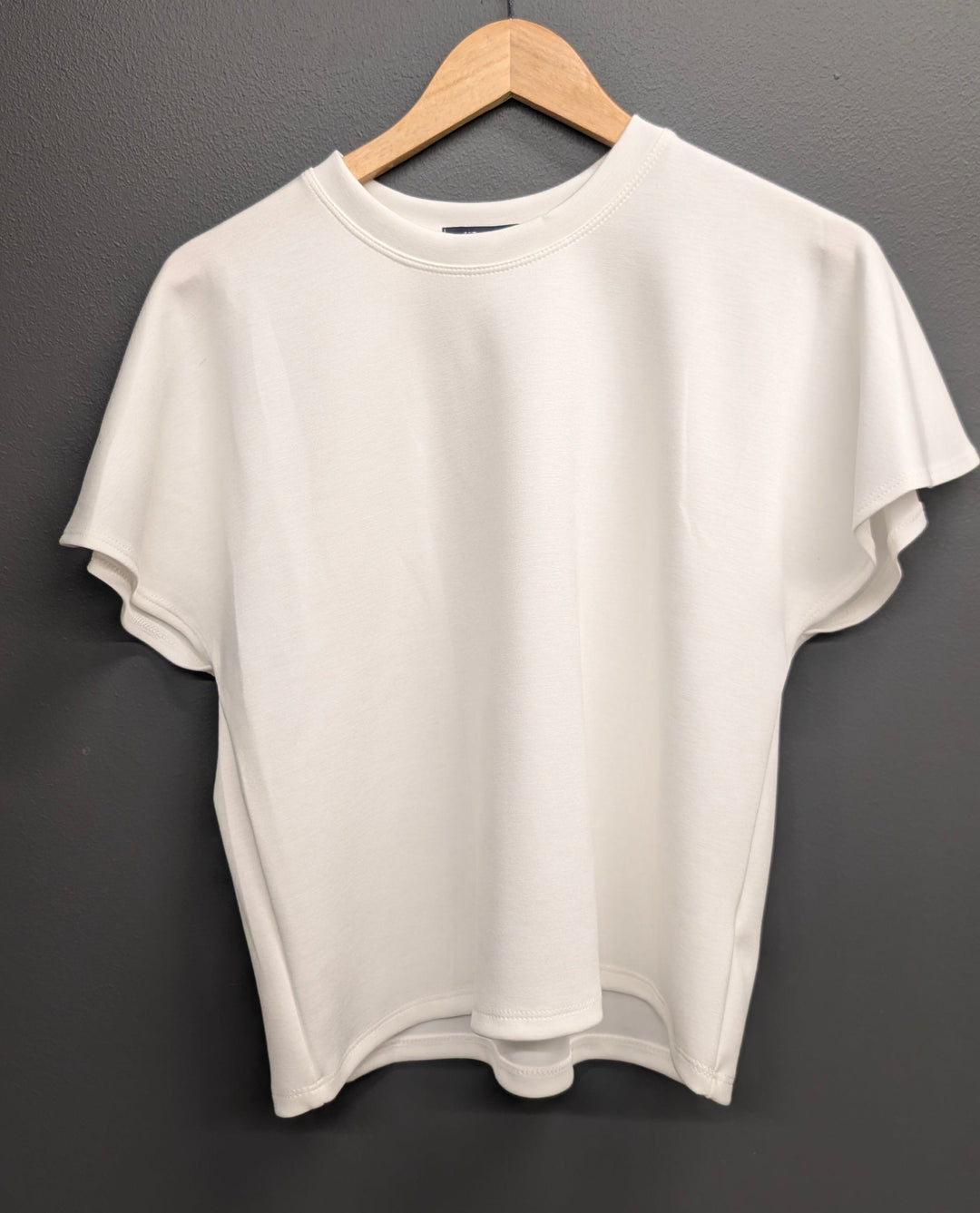 White Alessia Flared Top by KLd. Signature, casual sleeveless top with a flared hem, displayed on a plain background.