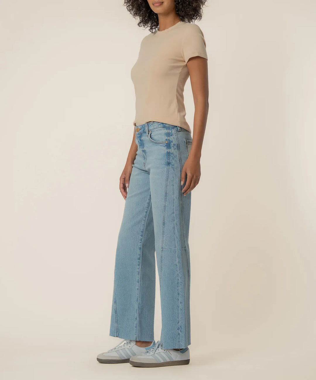KUT from the Kloth Meg high-rise wide-leg denim jeans in long length, showing the fit and classic blue denim fabric.