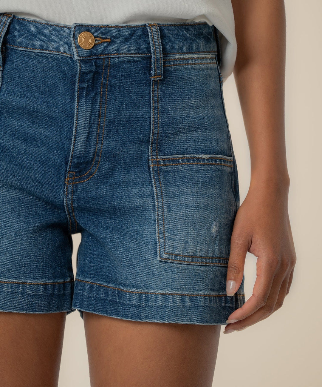 KUT from the Kloth Jane High Rise Short in medium wash denim with pork chop pockets, showcasing front view and high-rise fit.
