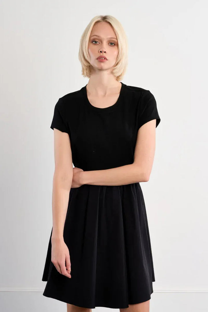 Black Lili Sidonio Elena drawstring mini dress shown on a model, featuring a fitted silhouette and stylish design.