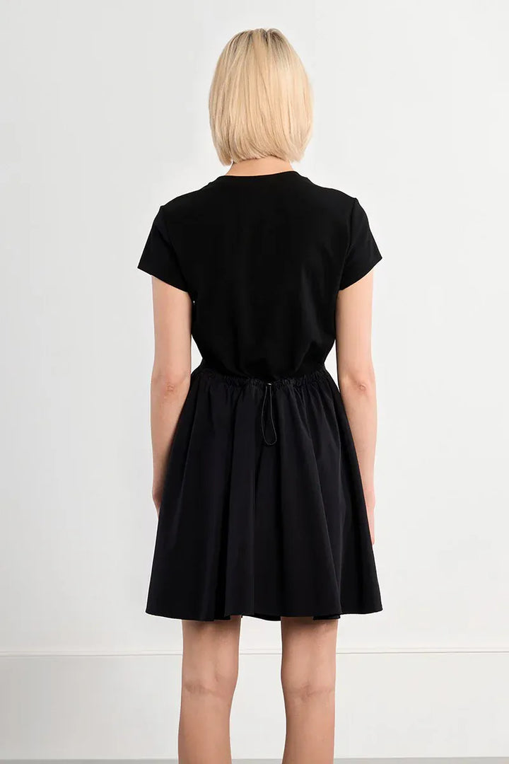 Lili Sidonio Elena drawstring mini dress in lightweight fabric, featuring a fitted silhouette and adjustable drawstrings at the sides.