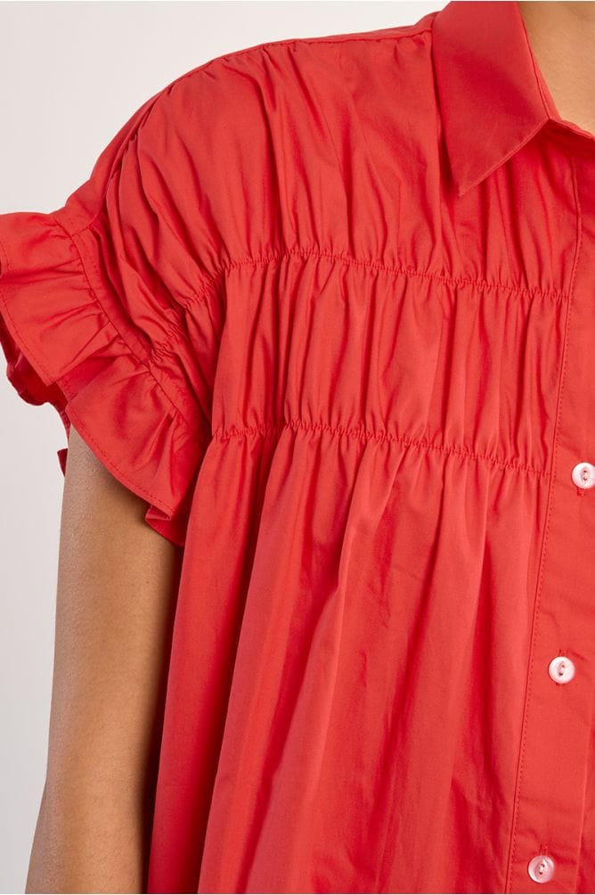Lili Sidonio Nikki Shirt Dress displayed on a hanger, showcasing its casual yet stylish design with button details and collar.