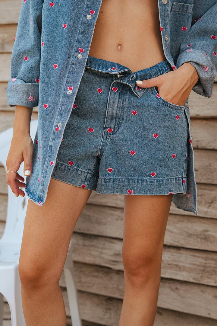 Lili Sidonio Hanna Multi-Hearts denim shorts with colorful heart pattern, casual fit, and distressed details.