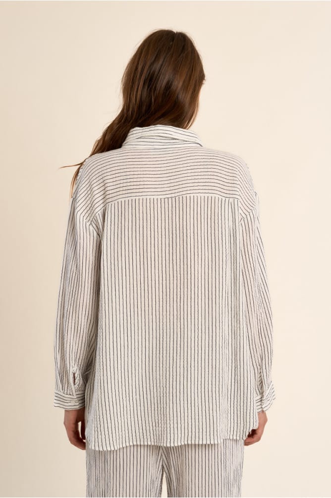 Lili Sidonio Diana oversized striped top featuring bold horizontal black and white stripes, relaxed fit, and long sleeves.