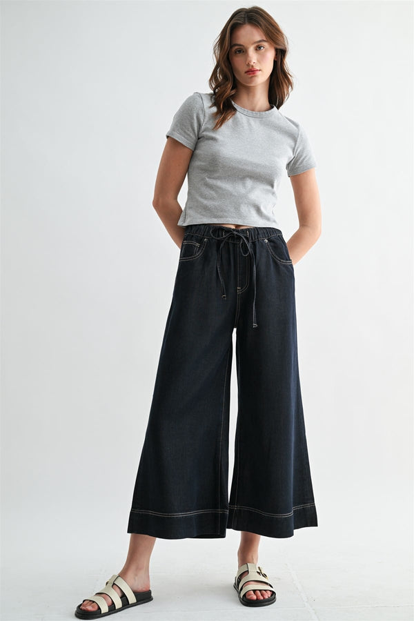Dark denim Leah Wide Leg Jogger by Mica Denim, showcasing relaxed fit and wide-leg style with front pockets and cuffed hems.