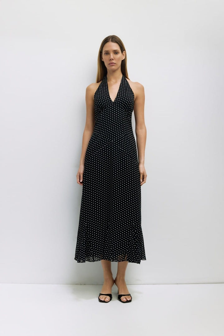 Black and white MOD REF Angelina Maxi Dress displayed on a hanger, showcasing its elegant design and flowing fabric.