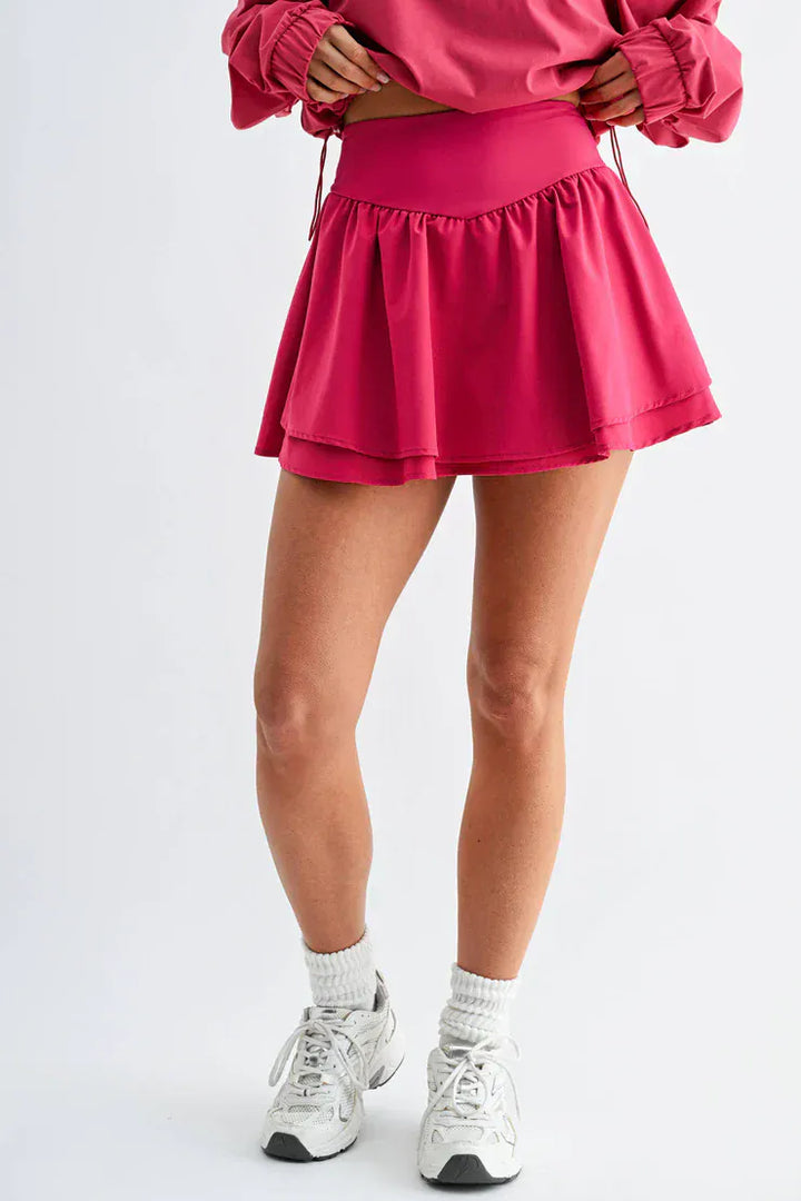 Mono B Breeze Flutter Skort in plum pink, featuring a lightweight, flowy design with built-in shorts and a comfortable waistband.