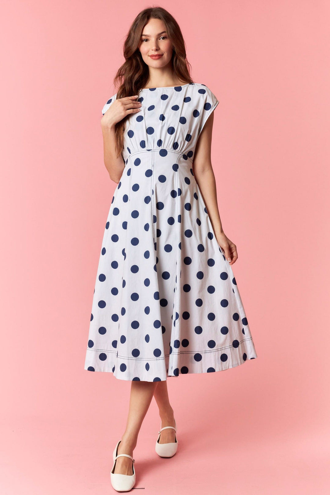 Navy polka dot midi dress by Peach Love California featuring a flowy silhouette and sleeveless design.