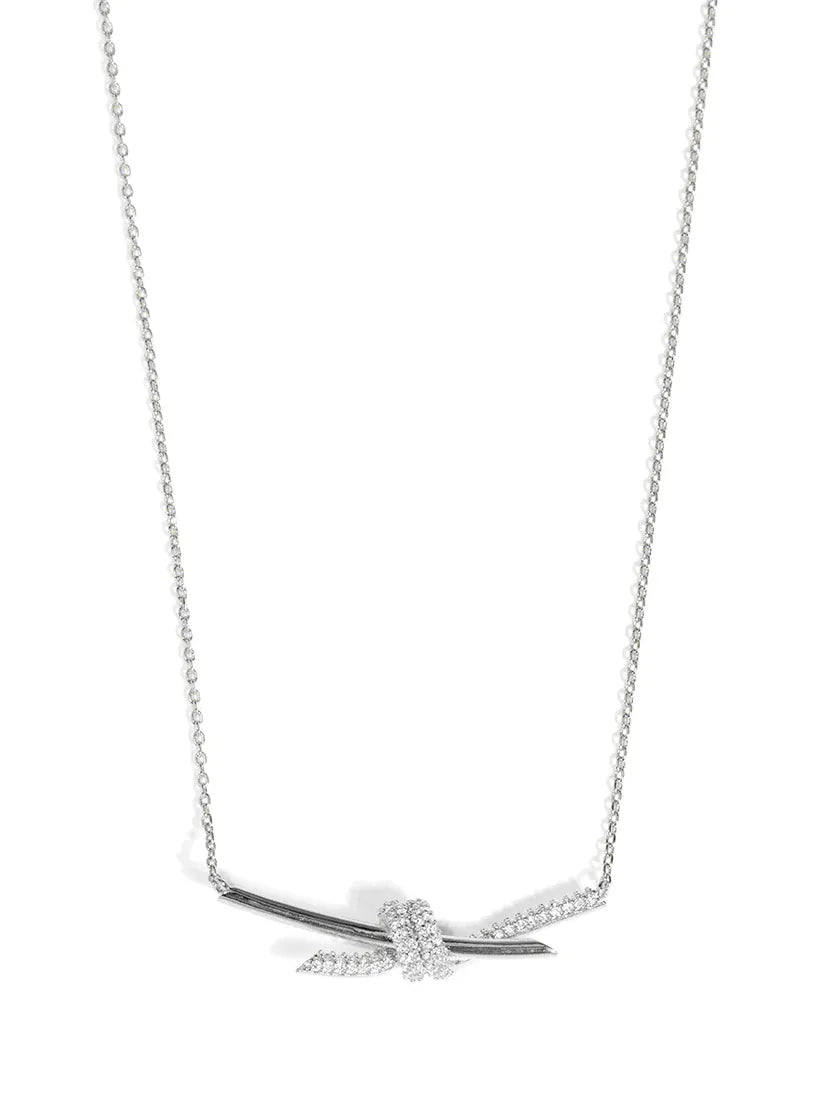 RHO Jewelry pave knotted pendant short necklace featuring a delicate, sparkling design with a gold-tone chain and pendant.